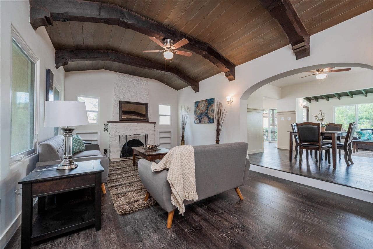 A living room with wood floors and vaulted ceilings.