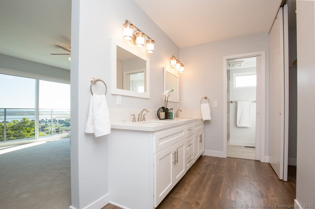 A bathroom with two sinks and a mirror.