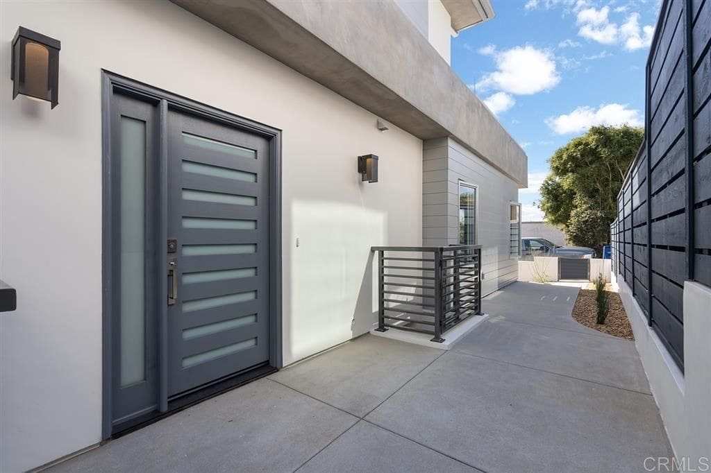 A building with a large gray door and white walls.