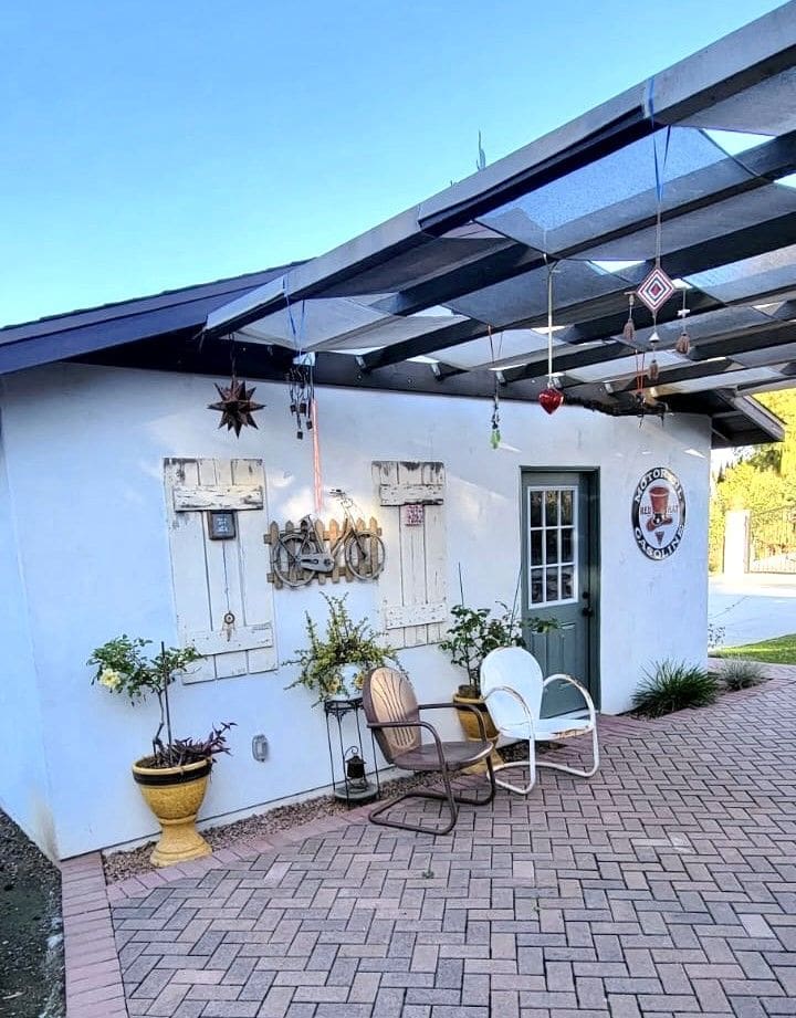 A white building with two chairs and a table.