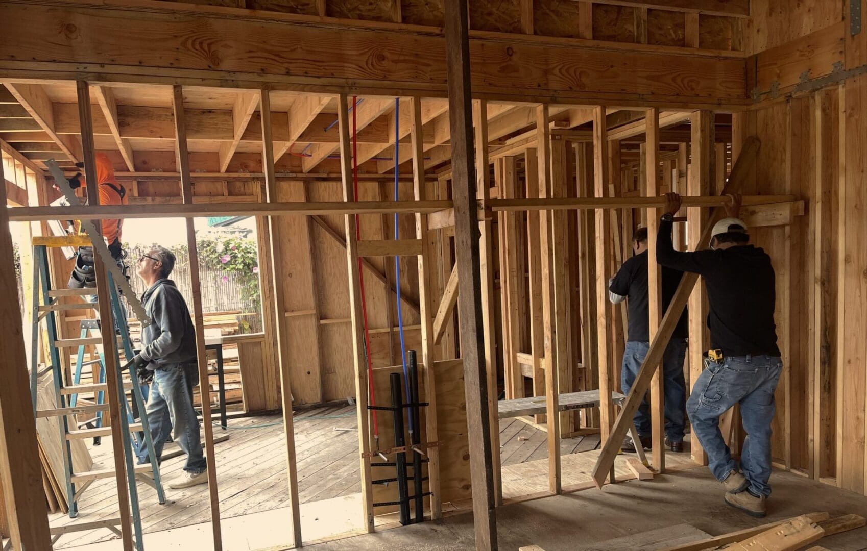 A group of people in a room with wood framing.